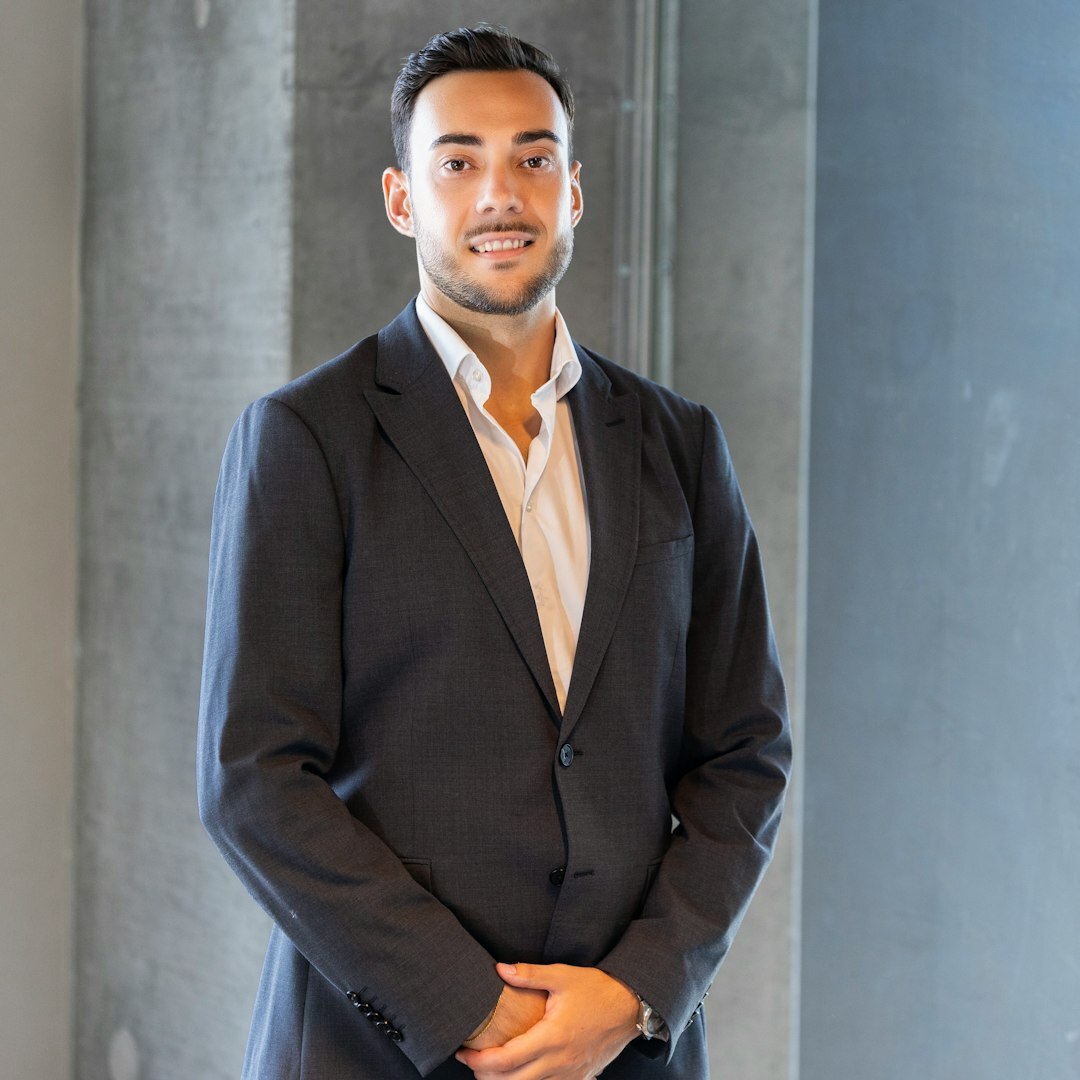 Professional Turkish male technology expert with warm smile and dark hair