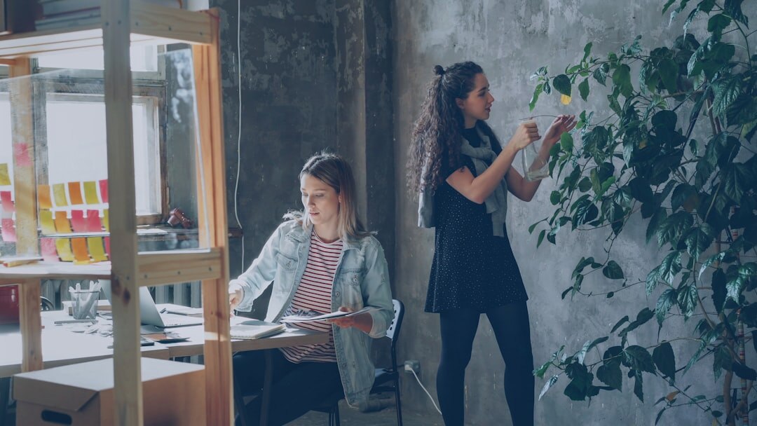 Startup team collaborating in modern office with whiteboards and sticky notes